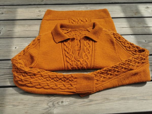 Pull col polo présenté sur table